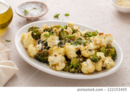 Roasted broccoli and cauliflower on a serving plate with herbs and spices 122153405
