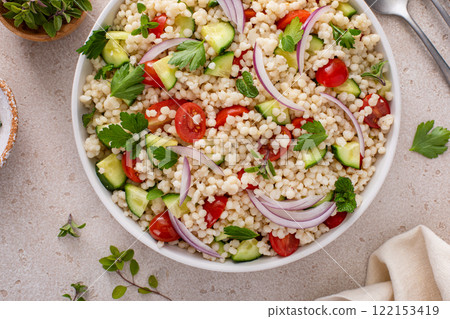 Pearl couscous salad with fresh vegetables and red onion Pearl couscous salad with fresh vegetables and red onion 122153419