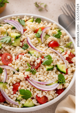 Pearl couscous salad with fresh vegetables and red onion Pearl couscous salad with fresh vegetables and red onion 122153424