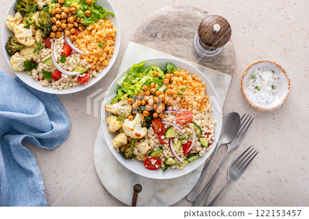 Vegan lunch bowl with lentils, roasted vegetables and chickpeas, pearl couscous salad 122153457