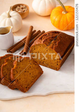 Pumpkin bread freshly baked sliced on a serving board, Thanksgiving dessert Pumpkin bread freshly baked sliced on a serving board, Thanksgiving dessert 122153476