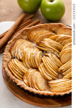 Apple pie or tart filled with sliced apples arranged on a pie base 122153525