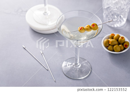 Martini cocktail with vodka, vermouth and olive garnish Martini cocktail with vodka, vermouth and olive garnish 122153552