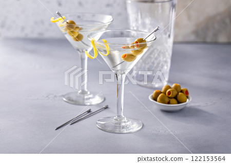 Lemon drop martini cocktail with olives and a lemon twist Lemon drop martini cocktail with olives and a lemon twist 122153564