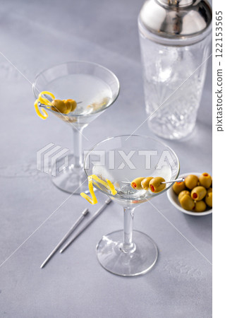 Lemon drop martini cocktail with olives and a lemon twist 122153565