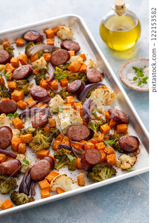 Sheet pan dinner with sausage and vegetables roasted and ready to eat Sheet pan dinner with sausage and vegetables roasted and ready to eat 122153582