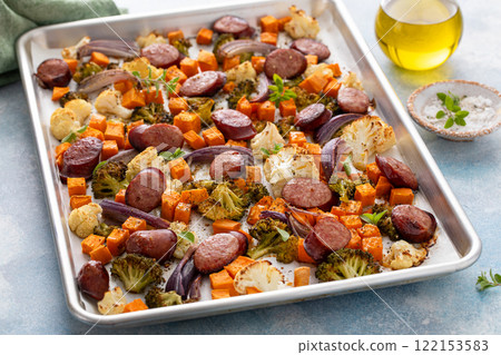 Sheet pan dinner with sausage and vegetables roasted and ready to eat 122153583