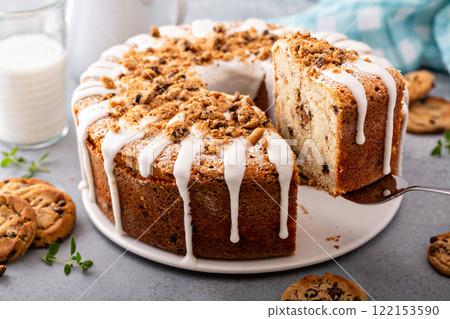 Glazed bundt cake with cookie crumbles on kitchen counter 122153590