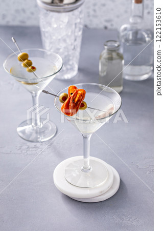 Martini with olive and salami garnishes Martini with olive and salami garnishes 122153610