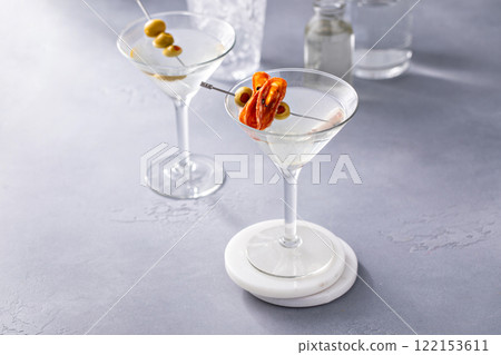 Martini with olive and salami garnishes Martini with olive and salami garnishes 122153611