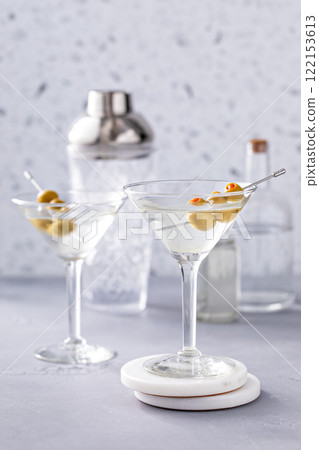 Martini cocktail with vodka, vermouth and olive garnish Martini cocktail with vodka, vermouth and olive garnish 122153613