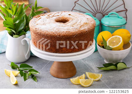 Lemon poppy seed pound cake baked in a bundt pan topped with powdered sugar Lemon poppy seed pound cake baked in a bundt pan topped with powdered sugar 122153625