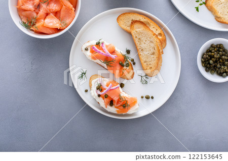 Making bruschetta with cream cheese, smoked salmon with toast and capers Making bruschetta with cream cheese, smoked salmon with toast and capers 122153645