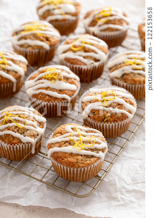 Lemon drizzle zucchini muffins on cooling rack Lemon drizzle zucchini muffins on cooling rack 122153658