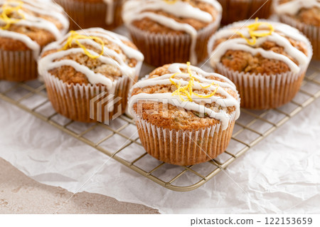 Lemon drizzle zucchini muffins on cooling rack Lemon drizzle zucchini muffins on cooling rack 122153659