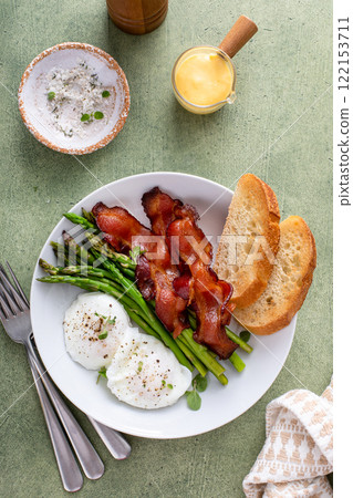 Poached eggs with bacon and asparagus for breakfast 122153711