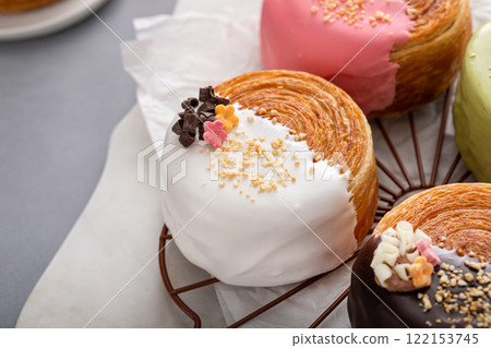 Round croissants with filling and glaze, trendy dessert Round croissants with filling and glaze, trendy dessert 122153745