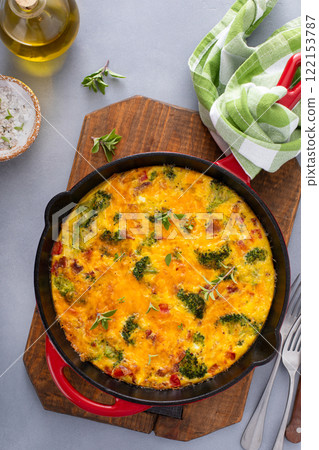 Healthy frittata or quiche with broccoli and red pepper whole in a cast iron pan 122153787