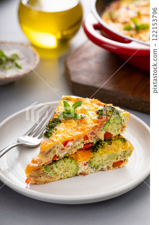 Healthy frittata or quiche with broccoli and red pepper, two slices on plate 122153796