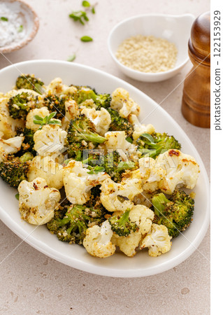 Roasted cauliflower and broccoli on a serving plate, healthy vegetable side dish 122153929