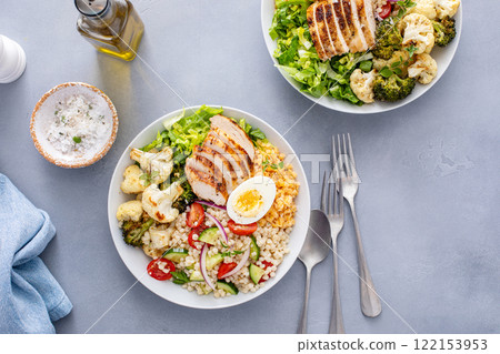 Healthy lunch bowl with grilled chicken, roasted vegetables, fresh lettuce, cooked lentils, salad and boiled egg 122153953