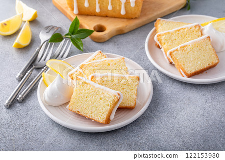 Lemon pound cake slices on a plate with whipped cream Lemon pound cake slices on a plate with whipped cream 122153980