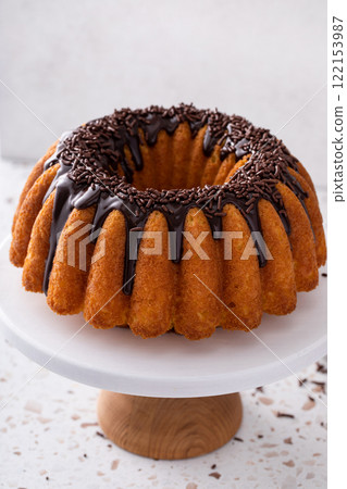 Traditional pound cake topped with chocolate ganache and chocolate sprinkles Traditional pound cake topped with chocolate ganache and chocolate sprinkles 122153987