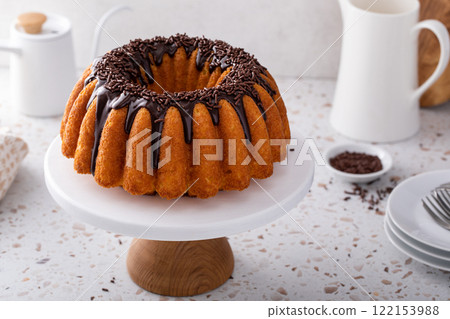 Traditional pound cake topped with chocolate ganache and chocolate sprinkles Traditional pound cake topped with chocolate ganache and chocolate sprinkles 122153988