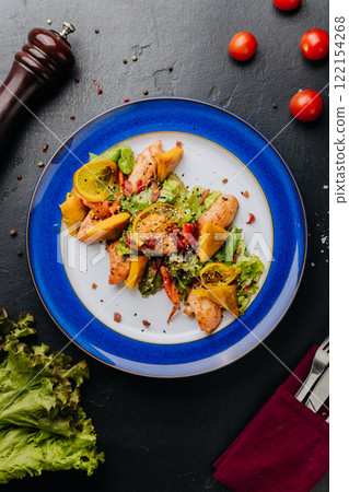 Grilled chicken salad with citrus and greens, a perfect mix of freshness and savory flavors 122154268