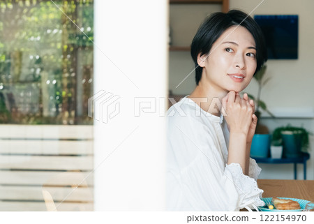 Woman looking out the window Woman looking out the window 122154970