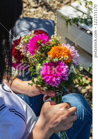Creating a vibrant floral bouquet in a sunny garden on a joyful afternoon 122155170
