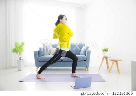 A young woman stretching A young woman stretching 122155369
