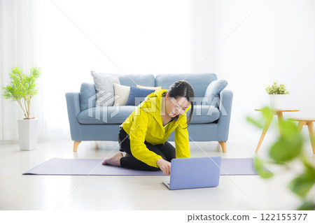 A young woman stretching A young woman stretching 122155377