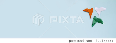 Banner origami three paper pigeons orange, white, green on blue light background 122155534