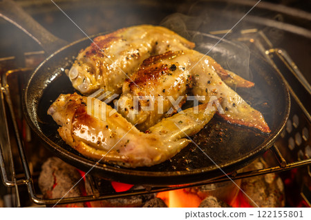 Chicken steak outdoors at a campsite Chicken steak outdoors at a campsite 122155801