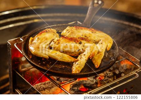 Chicken steak outdoors at a campsite Chicken steak outdoors at a campsite 122155806