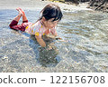 Summer memories of a girl playing in the sea 122156708