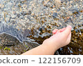 Hands of a girl playing in the river 122156709