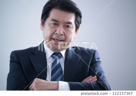 Senior business owner businessman with folded arms worried about management crisis Senior business owner businessman with folded arms worried about management crisis 122157367