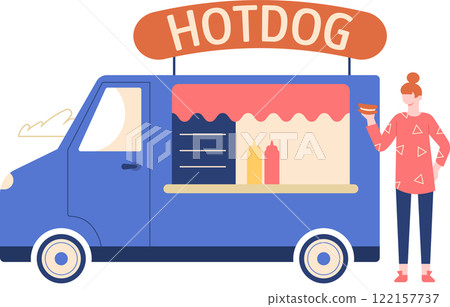 Customer holding a hot dog while standing near a vibrant blue food truck, showcasing bottles of mustard and ketchup on the counter, enjoying a delicious street food experience 122157737