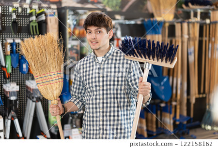 Guy chooses a broom Guy chooses a broom 122158162