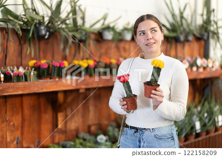 Girl buy potted flowering cactus plant in shop 122158209
