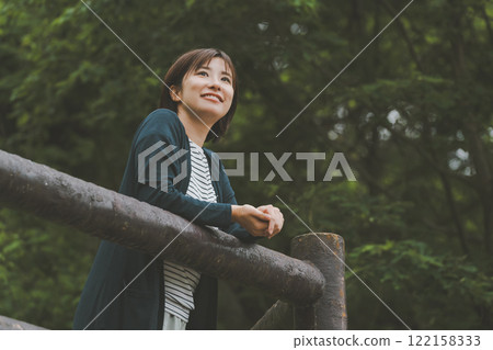 A mountain covered in fresh greenery and a young woman 122158333