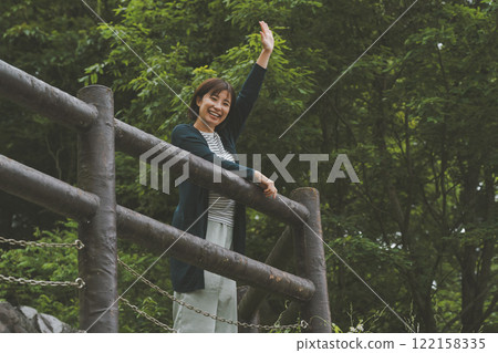 A mountain covered in fresh greenery and a young woman 122158335