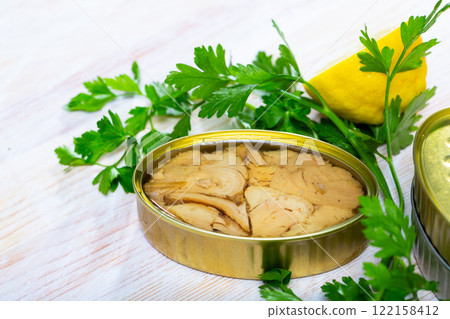 Canned tuna fish on a wooden table 122158412