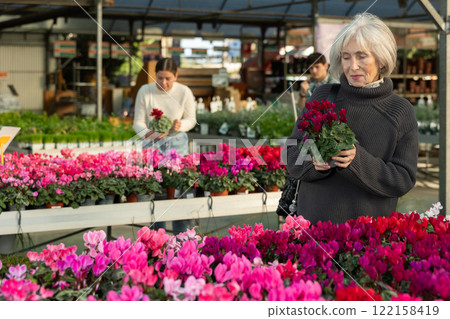 Elderly woman choosing flower pots 122158419