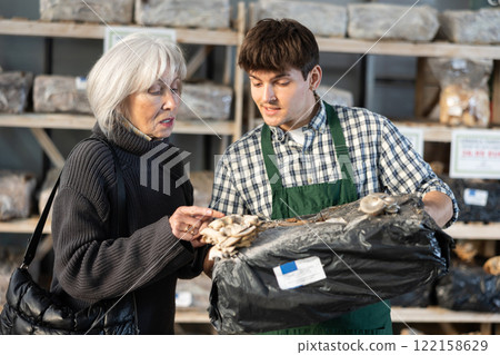 Guy consultant seller, presents mycelium to senior female buyer Guy consultant seller, presents mycelium to senior female buyer 122158629
