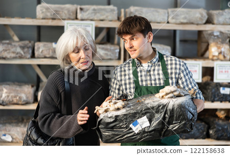 Older woman choosing mycelium in a garden store Older woman choosing mycelium in a garden store 122158638