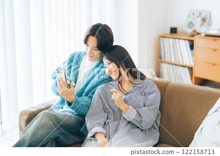 Young couple looking at smartphone together Young couple looking at smartphone together 122158713