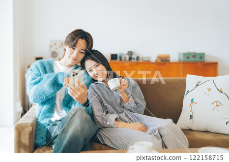 Young couple looking at smartphone together Young couple looking at smartphone together 122158715